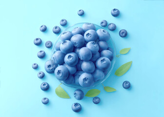 A view from above on delicious and juicy blueberries on a light blue background. Tasteful, raw and ripe blueberries full of vitamins. Organic ingredients for nutritious summer desserts. . High quality
