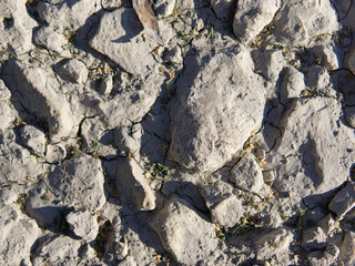 Abstract volumetric texture of gray color with strong shadows in the sun. Close