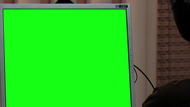 Sound Engineer Working with Computer Monitor Green Screen at A Recording Studio. Close Up. You can replace green screen with the footage or picture you want with “Keying” effect in After Effects.