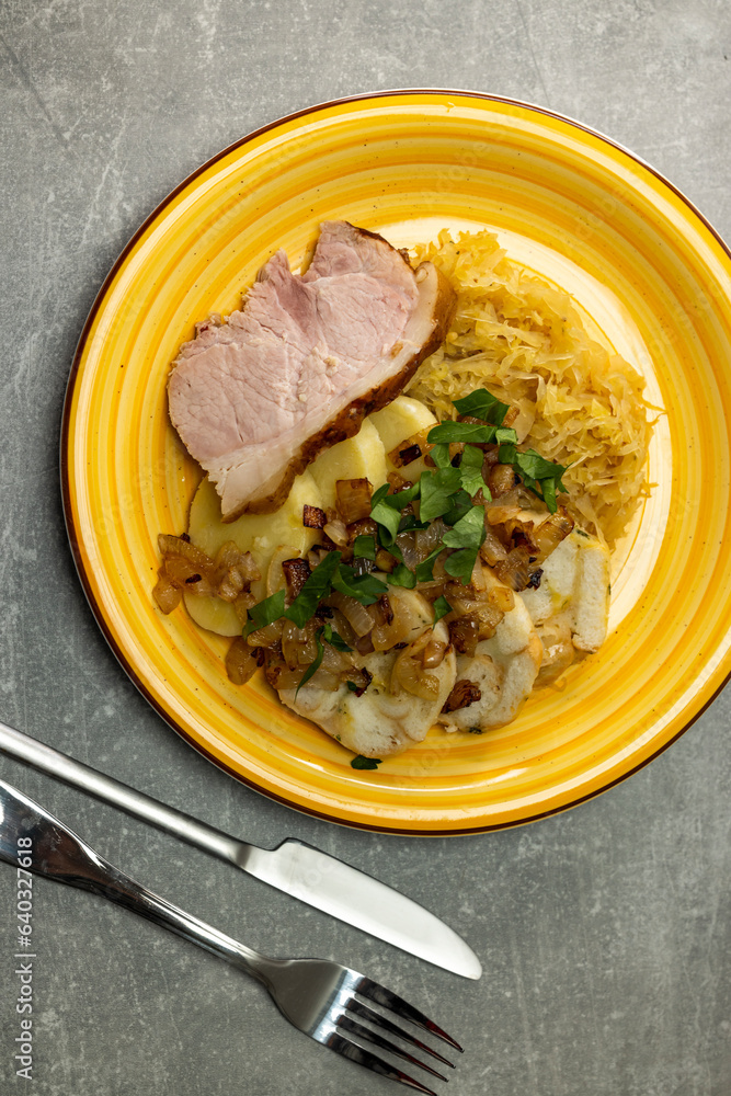 Wall mural pork meat with potato dumplings and pickled cabbage served with roasted onion