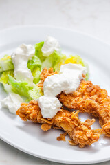 fried chicken in cornflakes with lettuce and garlic dip