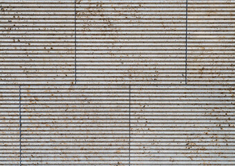 texture of a tiled beige stone wall with a horizontal joint pattern as background, natural stone wall texture as background. Close-up of a wall clad in limestone
