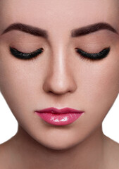Beautiful close-up shot of female with long false lashes. Young woman with perfect natural make-up, pink eyelash extensions. Macro beauty photo of fashion volume lash extension set, sexy full lips
