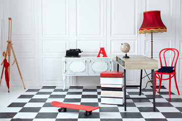 Interior of child room with desktop, red chair and dresser. Modern interior arranged in white and...