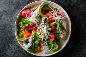Fresh sashimi salad with salmon fish, tuna and vegetables