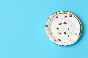 Paper disposable plate on blue background