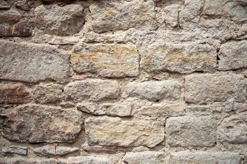 Stone wall with old bricks of the acient castle.