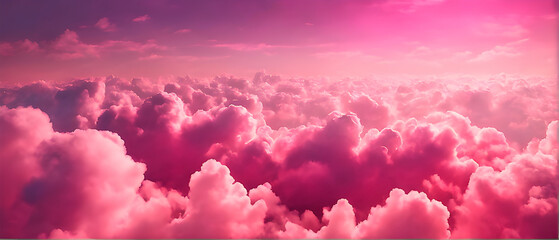 View from above of an abstract pink sky with fluffy pink clouds.