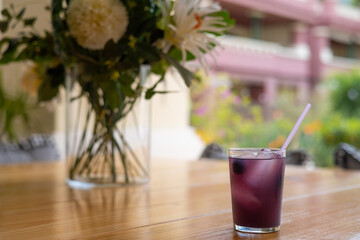 Glass Of Refreshing Drink With Blackberry And Straw, On A Wooden Table In The Garden Of The House