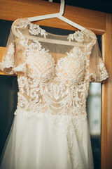 In the heart of the moment, the bride's dress steals the spotlight. From the midsection upwards, a vision of beauty and dreams realized shines forth.