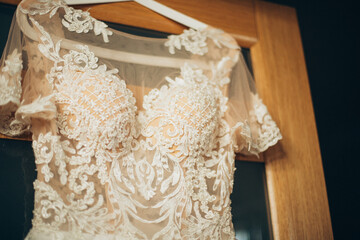 Sunlit elegance and intricate design converge in highlighting the bride's gown's top.
