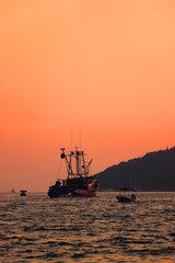 Fishing boat sailing at sunset, in Vela Luka, island Korcula, Croatia. 