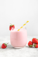 Glass of tasty strawberry smoothie on table