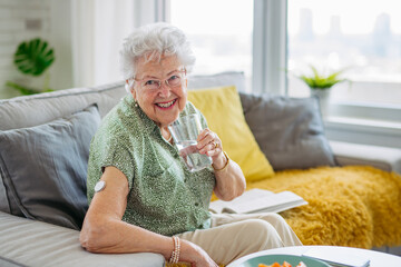Senior woman drinking water to better manage her diabetes.