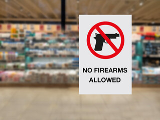 No firearms allowed sign posted on a shop glass window. Concept image. - 640368699