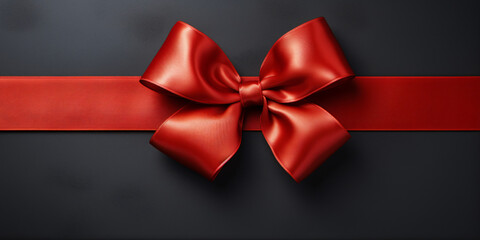 red ribbon and bow with gold isolated against dark gray background