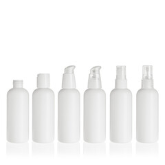 Group of white cosmetic transparent bottles isolated on white background with disc top cap, lotion pump and spray pump. Packaging of bottles for cosmetics and medical products.