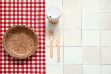 Beautiful table setting for picnic on white tile background