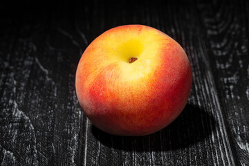 single peach on wood background