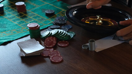man playing roulette wheel in casino
