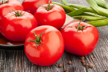 pink tomato on wood background