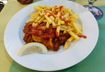 Vienna schnitzel and French fries. Traditional Austrian dish.