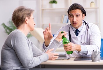 Female alcoholic visiting young male doctor