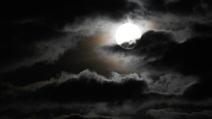 clouds moving slowly in front of full moon - Powered by Adobe