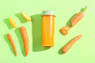 Sports bottle of fresh carrot juice with orange on green background