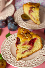 Sweet fluffy cake with fresh plums and hazelnuts - 640386079