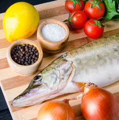Uncooked fish on cutting board in meal preparation concept