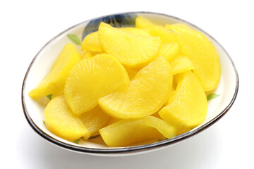 Sweet and tart slices of yellow pickled daikon, known as takuan in Japan and danmuji in Korea.