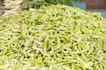 A bunch of fresh pea pods at the local market. Concept of grains and organic food.