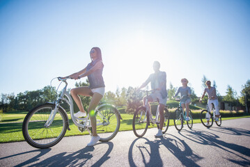 Friends cycling in park