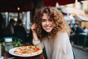 Girl eats pizza in street cafe