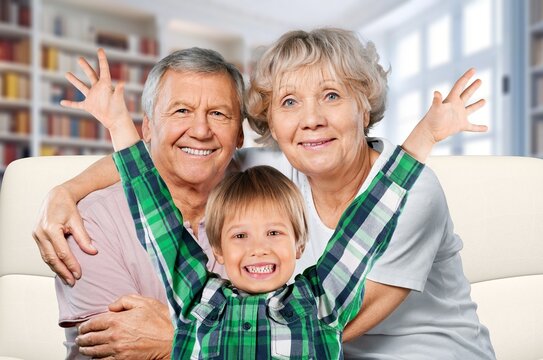 happy old grandparents with cute child at home, AI generated image