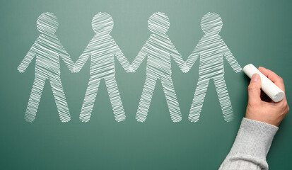 White chalk-drawn figures on a green chalkboard, representing the concept of friendship and mutual...