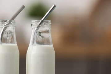 Bottles of fresh milk in kitchen, closeup