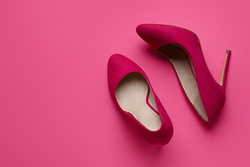 Stylish pink high heels on color background