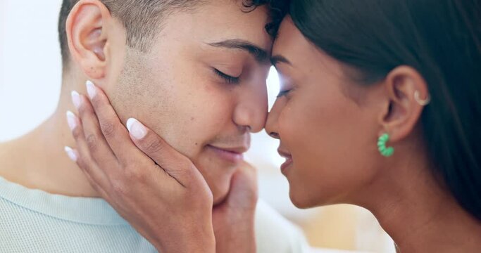 Hands on face, touch and a couple at home with love, support and care. Closeup of a man and woman partner together for healthy relationship, commitment and intimate moment with a smile and trust