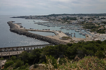 Santa Maria di Leuca, located at the southernmost tip of Italy's "heel" (aka the Salento peninsula), is shown from an elevated view during the day.