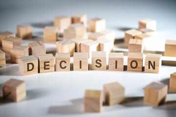 Word DECISION written on wooden cubes among a lot of others, concept to make the right choice in...