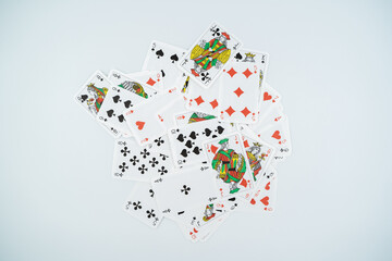 Scattered playing cards isolated on white background.
