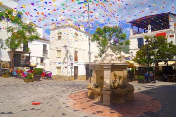 square in the old town of Casares with Fuente de Carlos III fountain and typical Andalusian whites...