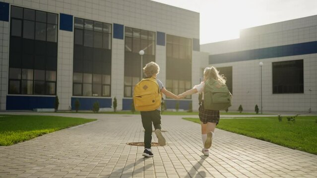 Happy School Kids Running To Lessons In Morning, Following Back View, Education And Development
