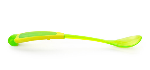 Green plastic spoon for baby isolated on white background