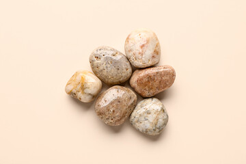 Many pebble stones on beige background