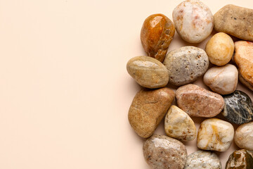 Fototapeta na wymiar Many pebble stones on beige background