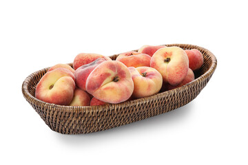 Wicker bowl with sweet fig peaches on white background