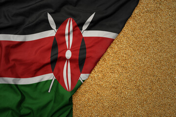 wheat grain on the waving colorful big national flag of kenya .